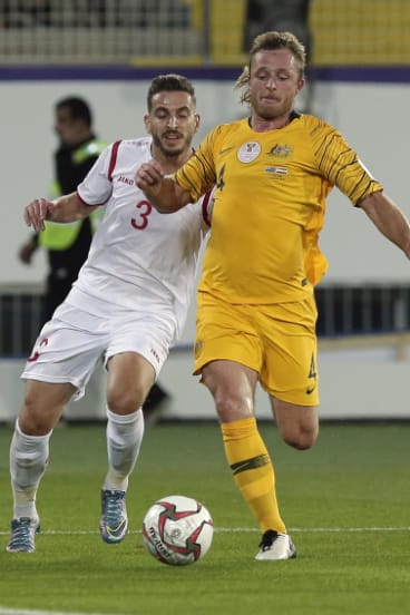 Defender Ryan Grant duels on the ball with Syrian defender Mouaiad Al Ajjan.
