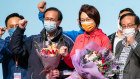 Starry Lee, centre, and her team celebrate on stage after winning the Legislative Council general election.