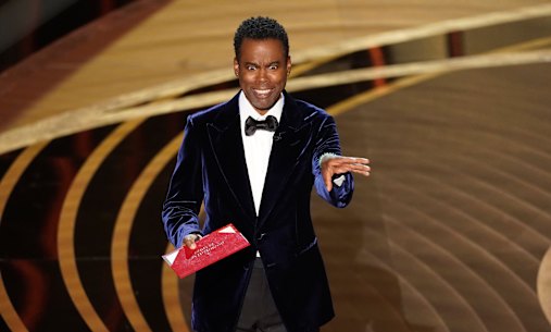Chris Rock on stage presenting the award for best documentary feature at the 2022 Oscars.