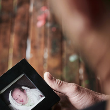 Daniel Wass looks at a photo of his son Sean who was abducted by his mother when he was a toddler. 
