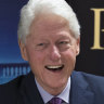 Former President Bill Clinton smiles as he signs autographs during an event to promote his new novel with author James Patterson, The President is Missing.