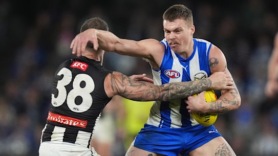 North Melbourne’s Cameron Zurhaar attempts to break a tackle by Collingwood’s Jeremy Howe.