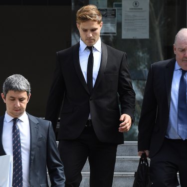 Jack de Belin leaves court in Wollongong with solicitor Robert Foster, left, and manager Steve Gillis.