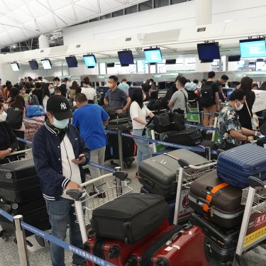 People queue up to check in for flights to the UK at Hong Kong airport in June. Having to prove you’ve been vaccinated and tested means it might take longer to get to where you’re going.