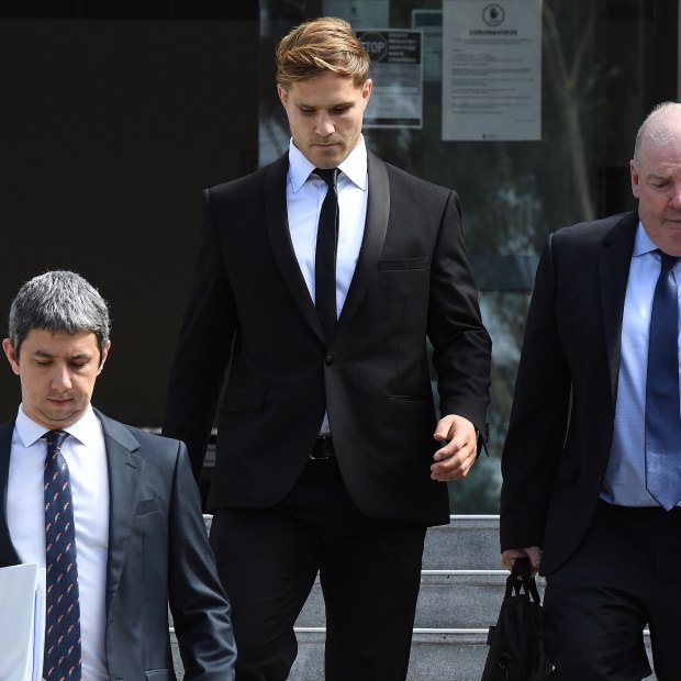Jack de Belin leaves court in Wollongong with solicitor Robert Foster, left, and manager Steve Gillis.