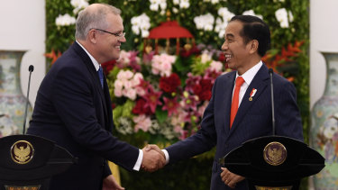 Prime Minister Scott Morrison with Indonesian President Joko Widodo at the Presidential Palace on Friday night.