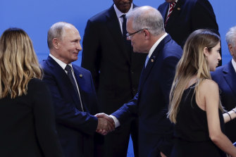 Prime Minister Scott Morrison greets Russian President Vladimir Putin at the G20 in 2018. Mr Morrison now says people who are invading other countries should not be at the summit.