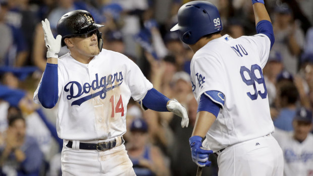 Los Angeles Dodgers' Enrique Hernandez, left, celebrates after a home run with Hyun-Jin Ryu.