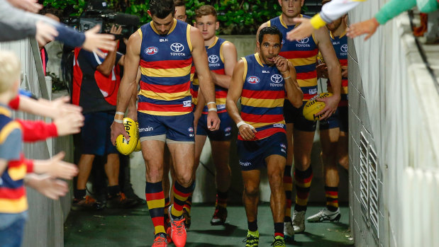 Taylor Walker prepares to lead the Crows out.