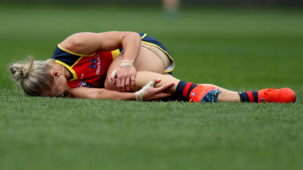 Erin Phillips clutches her knee after going down in the third quarter of the grand final.