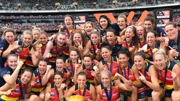 The Crows celebrate with the 2019 AFLW premiership cup.