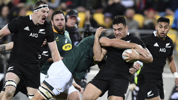 Far from invincible: New Zealand's Codie Taylor is hit by a South African tackler in Wellington, where the two sides drew in this year's Rugby Championship.
