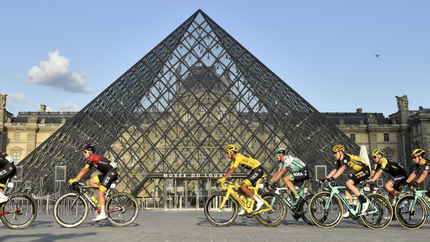 Colombia's Egan Bernal, centre, rides past the pyramid of the Louvre museum last year.