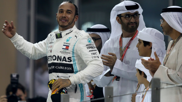Hamilton celebrates on the podium at the Yas Marina Circuit in Abu Dhabi.