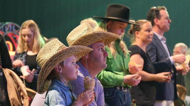 Dan O'Brien and Riley O'Brien, 4, watching the show of motorbike riders at the Ekka launch on Thursday.