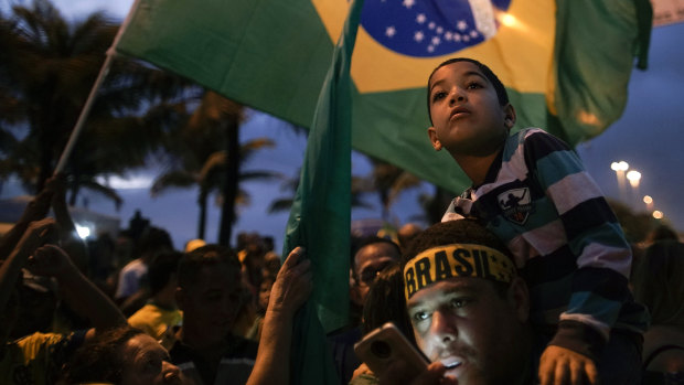 Supporters of Jair Bolsonaro wait for his victory speech, in Rio de Janeiro.