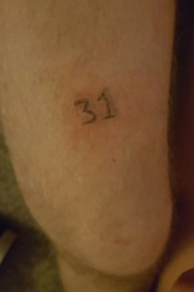 He asked for a 13 but they drew a ... 
The Queanbeyan man with this tattoo wasn't sure at first, but now he loves it.