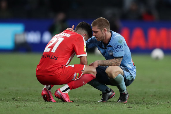 Luke Brattan consoles Ramy Najjarine after the final whistle. 