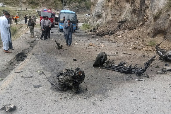 Police officers examine the site of suicide bombing at a highway in Shangla, north-west Pakistan.