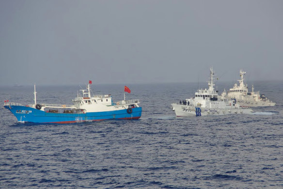 A suspected illegal Chinese fishing boat being monitored by the Japan Coast Guard.
