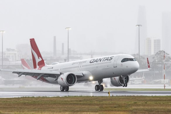 Soggy touch down: The new Qantas Airbus XLR 321 arrives in rainy Sydney.