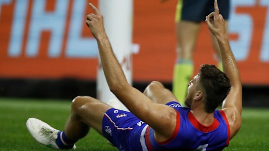 Marcus Bontempelli celebrates after booting a goal in the Bulldogs’ win over Melbourne.