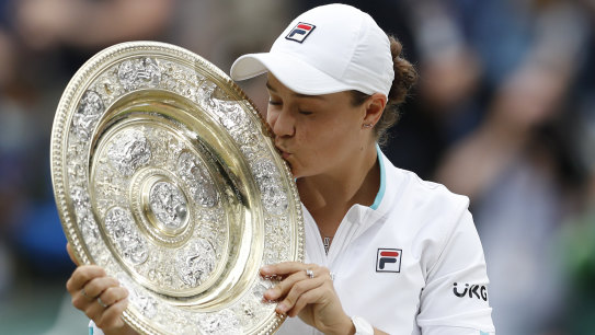 Ash Barty kisses the Wimbledon trophy after ending the 41-year drought for Australian women at the tournament in 2021.