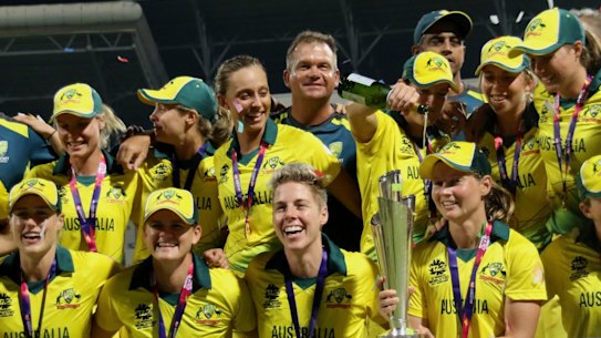 The Aussies celebrate with the trophy.
