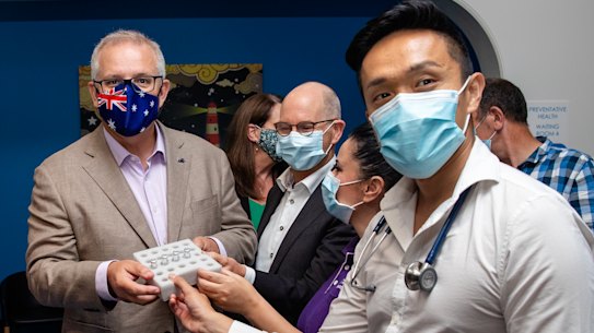 Dr Li, right, holding the vaccine vials. 
