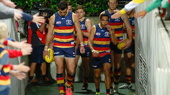 Taylor Walker prepares to lead the Crows out.