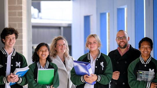 The Age has awarded Melba College its 2021 Schools that Excel government school winner for Melbourne’s east. Students Harry Pearson, Hser Tin, Gemma van Rooy and Thang Zathang, L to R, and assistant principal Allirra Scott with acting principal Matt Lee.