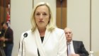 Christine Holgate takes her seat at the start of the Senate hearing on Australia Post at Parliament House.