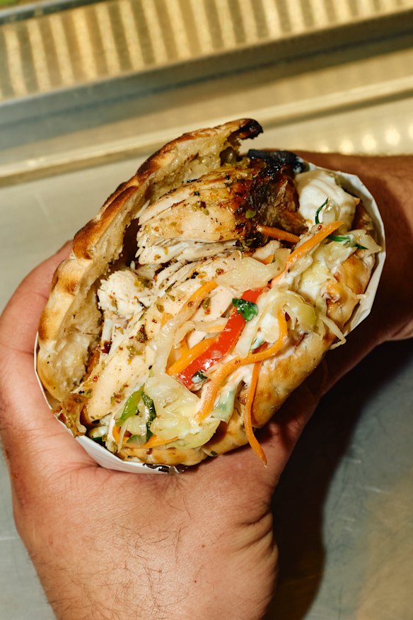 House flatbread souv stuffed with tarama, slaw and lemon chicken.