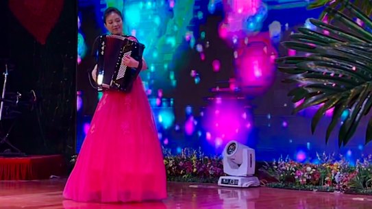 A North Korean musician plays the accordion during a Saturday dinner show at the Pyongyang Okryu-Guan restaurant in Beijing.