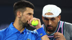 Novak Djokovic and Nick Kyrgios talk tactics during their match in Brisbane in 2024.