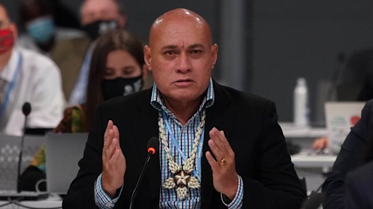 Tuvalu Finance Minister Seve Paeniu holds back tears while speaking.