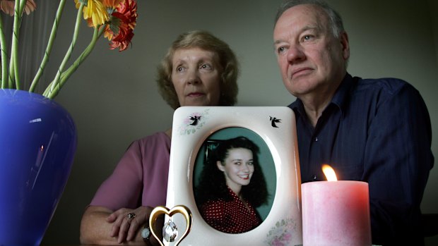Joy and Roger Membrey in 2005, with a picture of their daughter, Elisabeth, who was killed in 1994. There is a million-dollar reward for information on the Membrey murder.