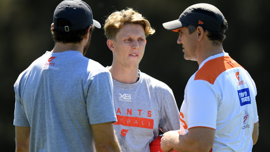 Lachie Whitfield of the Giants (centre) speaks with Shane Mumford (left) and coach Leon Cameron during a training session at the WestConnex Centre in Sydney, Tuesday, September 24, 2019. The GWS Giants are set to take on Richmond in the 2019 AFL Grand Final on Saturday. (AAP Image/Dan Himbrechts) NO ARCHIVING