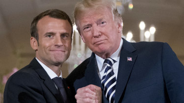 Trump and Macron embrace at the conclusion of their Tuesday news conference.