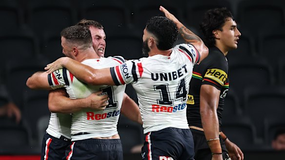 The Roosters celebrate Sandon Smith’s try.
