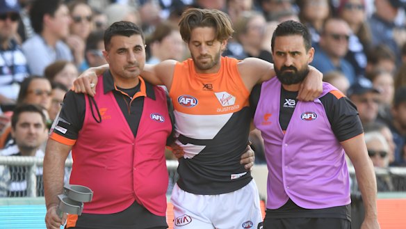 Ward is helped from the field after suffering a season-ending knee injury against Geelong.