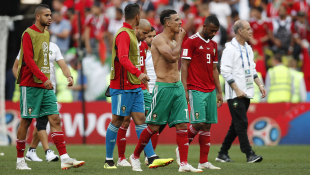 Eliminated: Morocco's players leave the pitch after their second-straight loss.