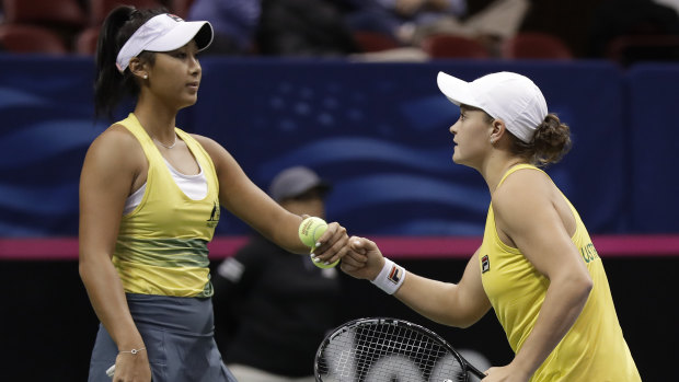 Barty (right) and Priscilla Hon celebrate a point in the doubles.