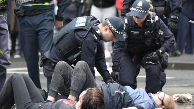 Activists glued themselves to the road last month during anti-mining protests in Melbourne.