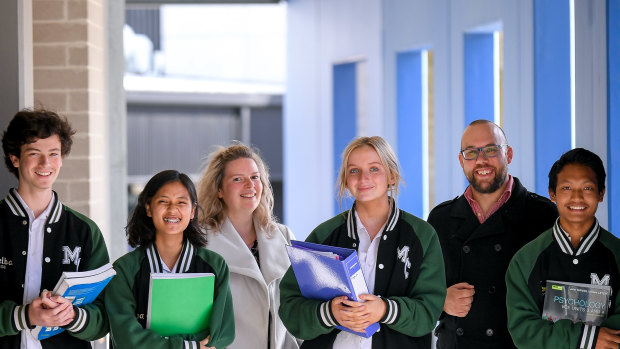 The Age has awarded Melba College its 2021 Schools that Excel government school winner for Melbourne’s east. Students Harry Pearson, Hser Tin, Gemma van Rooy and Thang Zathang, L to R, and assistant principal Allirra Scott with acting principal Matt Lee.