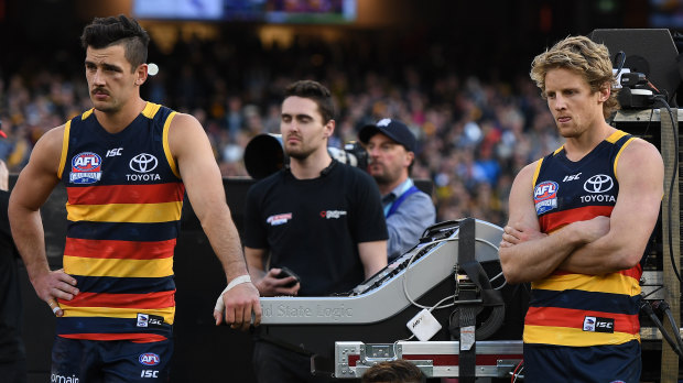 Taylor Walker (left) and Rory Sloane in the immediate aftermath of losing the 2017 grand final.