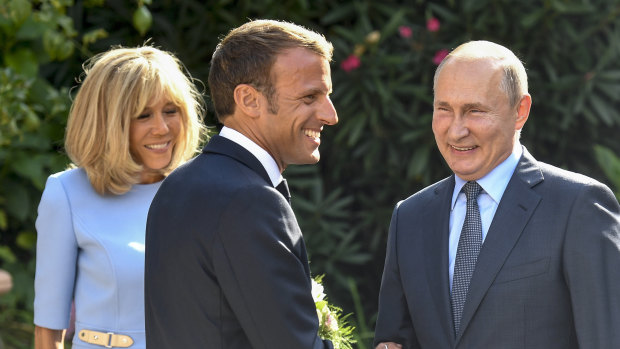 All smiles: French President Emmanuel Macron, his wife Brigitte, and Russian President Vladimir Putin.
