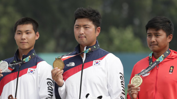 Not quite enough: Gold medalist South Korea's Kim Woo-jin, center, silver medalist South Korea's Lee Woo-seok and bronze medalist Indonesia's Riau Ega Agata.