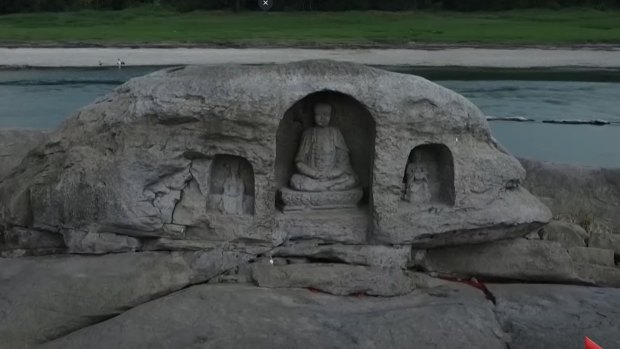 In China, the low water of the Yagntze River near the south-western city of Chongqing has revealed a trio of Buddhist statues believed to be 600 years old.