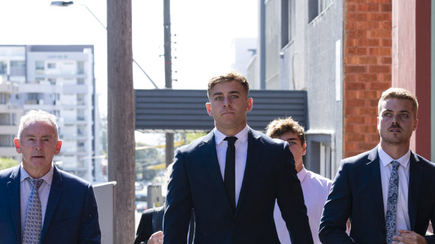 Callan Sinclair (centre) arrives at the NSW District Court in Wollongong.
